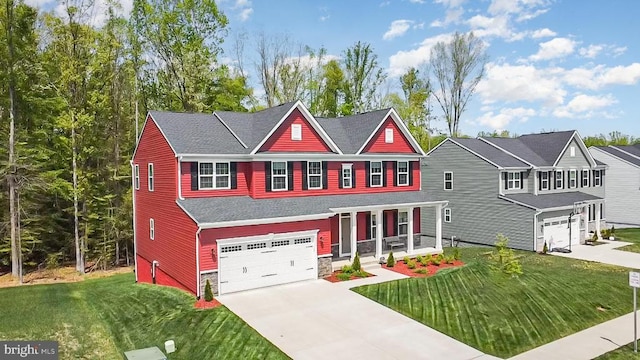 craftsman house featuring driveway, stone siding, covered porch, a garage, and a front yard