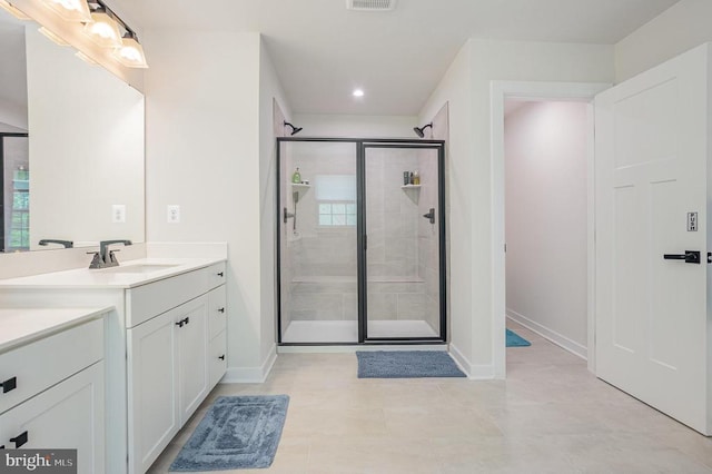 full bath with recessed lighting, baseboards, vanity, and a stall shower