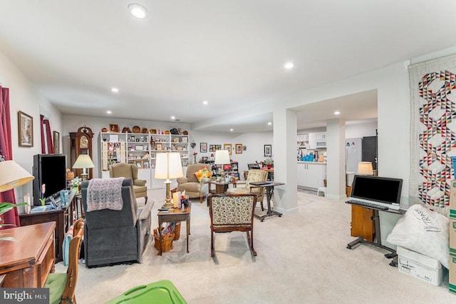 living room with recessed lighting and light colored carpet