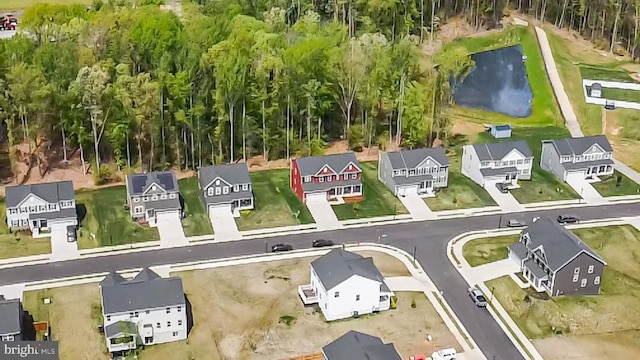 drone / aerial view with a residential view and a water view