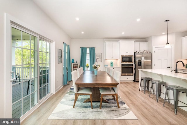 dining space featuring light wood-style floors and recessed lighting