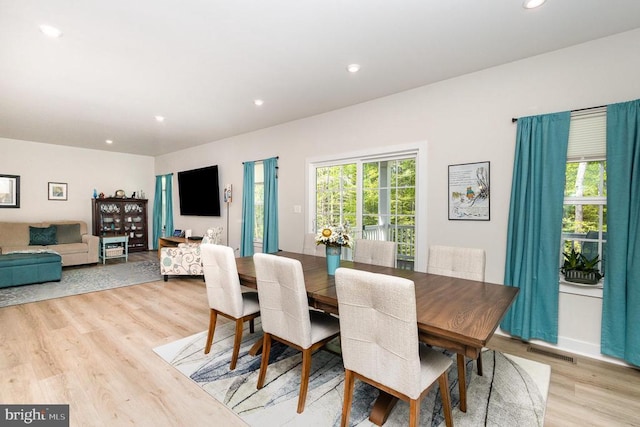 dining room featuring recessed lighting, light wood-style flooring, visible vents, and plenty of natural light