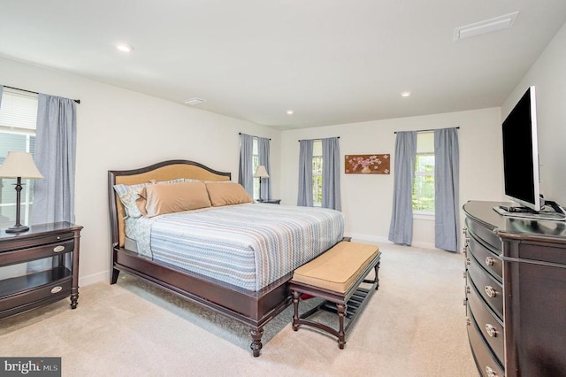 bedroom with baseboards, light carpet, and recessed lighting