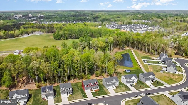 aerial view with a forest view, a water view, and a residential view