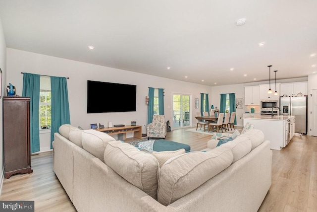 living area featuring recessed lighting and light wood-style floors