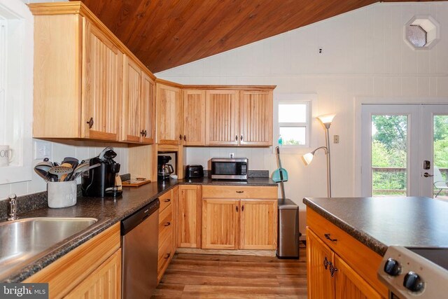 kitchen featuring vaulted ceiling, appliances with stainless steel finishes, sink, wood ceiling, and light wood-type flooring