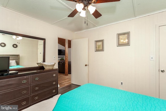 bedroom with ornamental molding, dark hardwood / wood-style floors, and ceiling fan