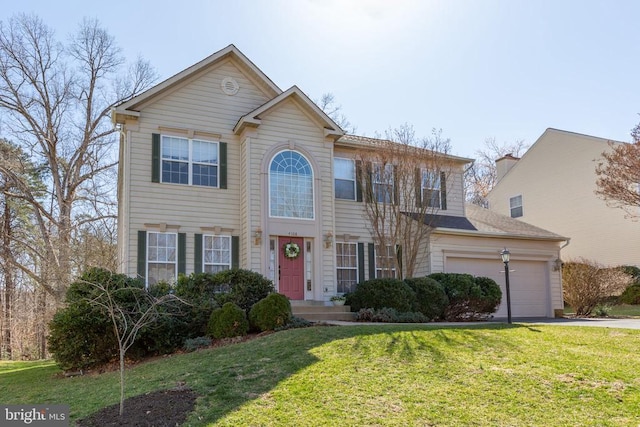 view of front of house with driveway, an attached garage, and a front yard