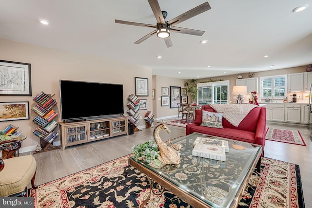 living room featuring light hardwood / wood-style floors and ceiling fan