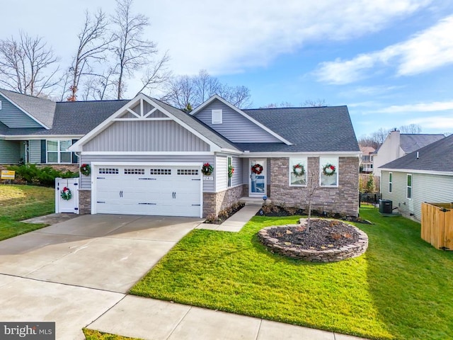 craftsman-style home with a garage, central AC unit, and a front lawn