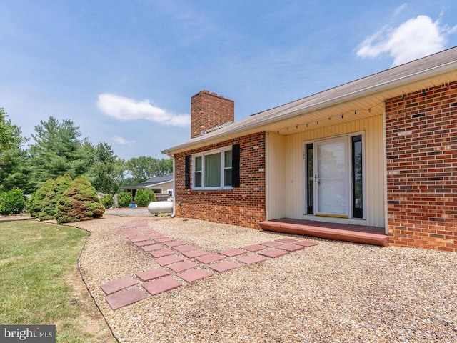 rear view of property featuring a yard