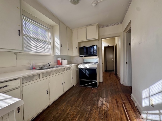 kitchen featuring white cabinetry, dark wood-type flooring, sink, and white stove