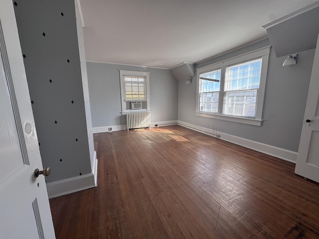 interior space with radiator, cooling unit, and dark hardwood / wood-style floors