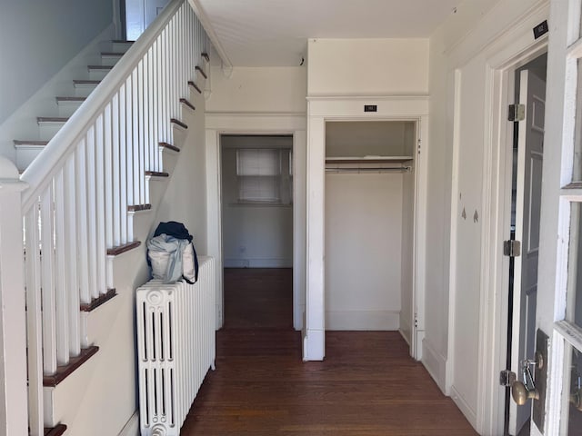 hall with dark hardwood / wood-style flooring and radiator