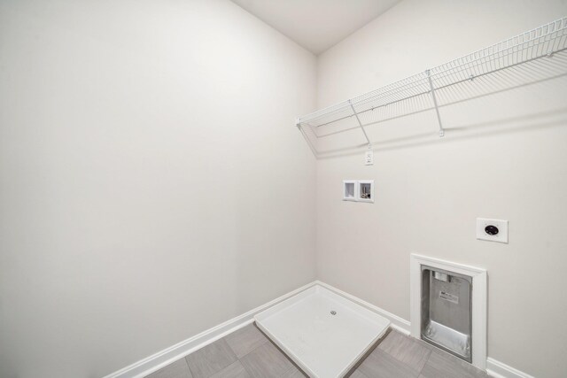 clothes washing area featuring hookup for a washing machine and hookup for an electric dryer