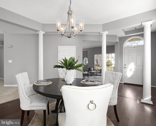 dining area with dark wood-type flooring and ornate columns