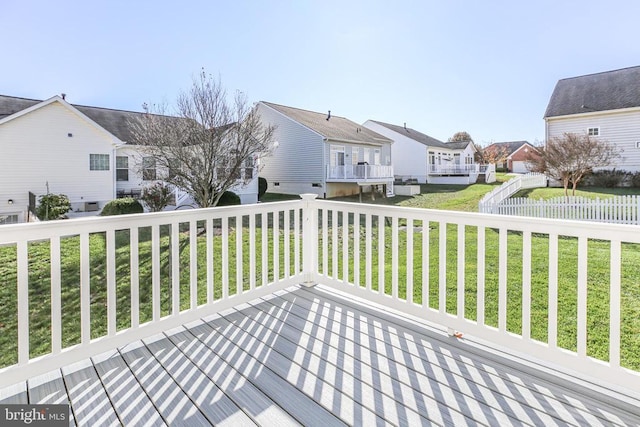 wooden deck with a residential view and a lawn