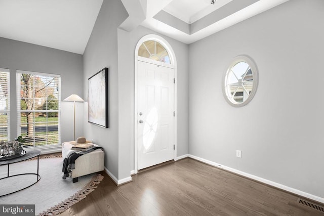 entryway featuring visible vents, baseboards, and wood finished floors