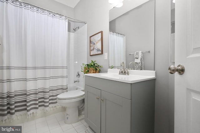 bathroom featuring tile patterned floors, shower / tub combo, toilet, and vanity