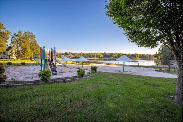 view of jungle gym with a water view and a lawn