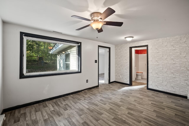 empty room featuring hardwood / wood-style flooring and ceiling fan