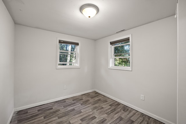 spare room with hardwood / wood-style floors and a wealth of natural light