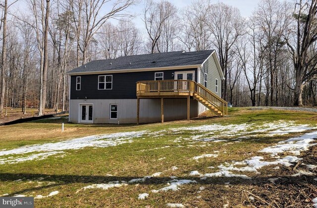 back of house with a wooden deck, a lawn, and french doors