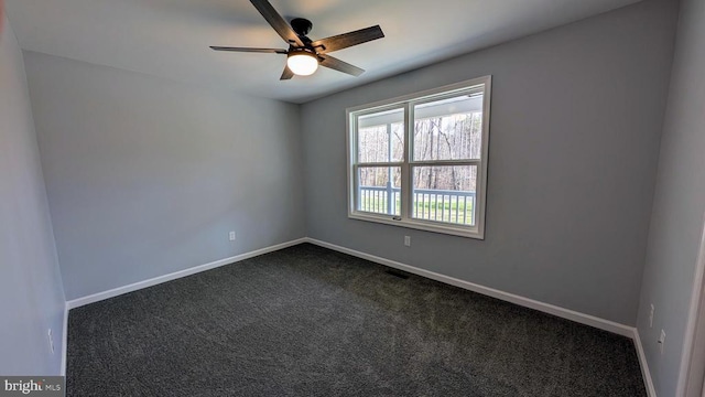 unfurnished room featuring ceiling fan and dark carpet