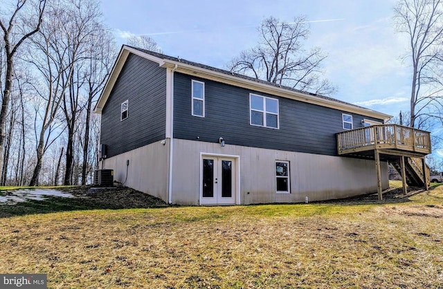 back of property featuring a wooden deck, a yard, central AC unit, and french doors