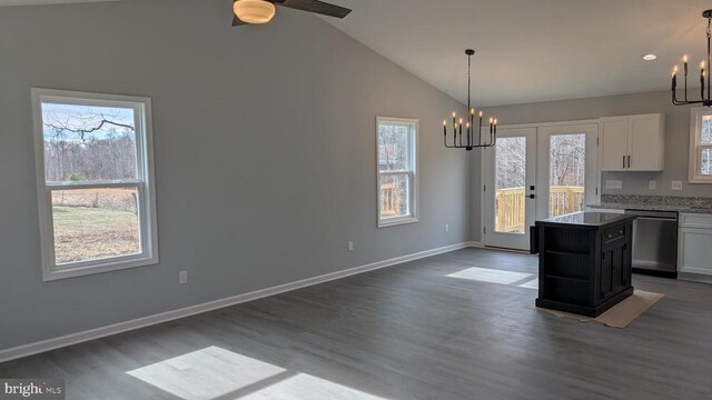 kitchen with white cabinetry, a kitchen island, dishwasher, and an inviting chandelier