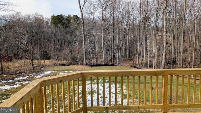 wooden terrace featuring a yard