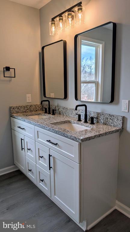 bathroom featuring vanity and hardwood / wood-style flooring