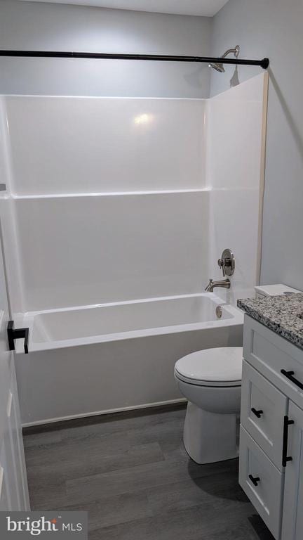 full bathroom featuring vanity, wood-type flooring, tub / shower combination, and toilet