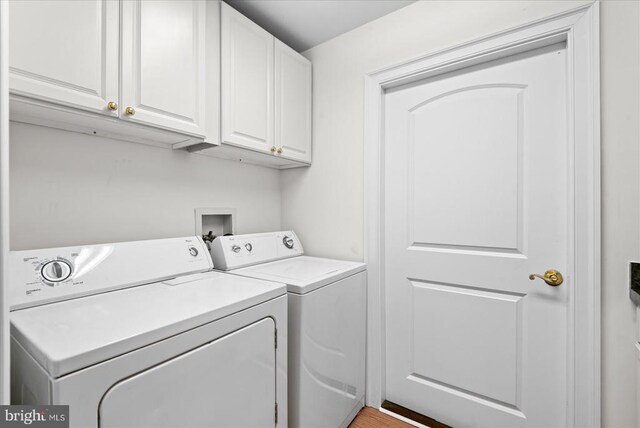 laundry room featuring washing machine and dryer and cabinet space