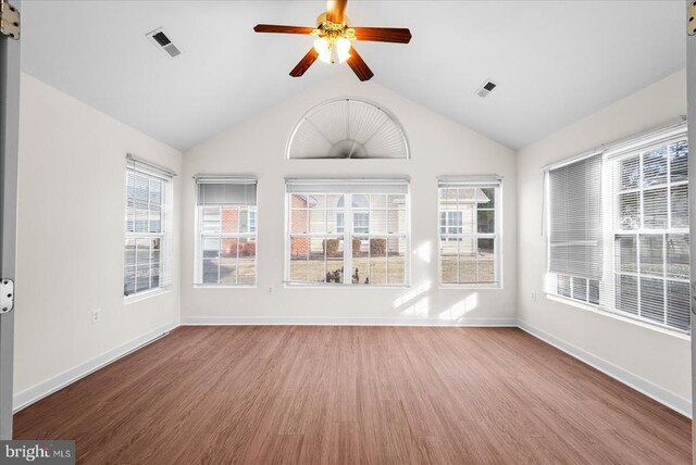 unfurnished sunroom featuring a ceiling fan, a wealth of natural light, and visible vents