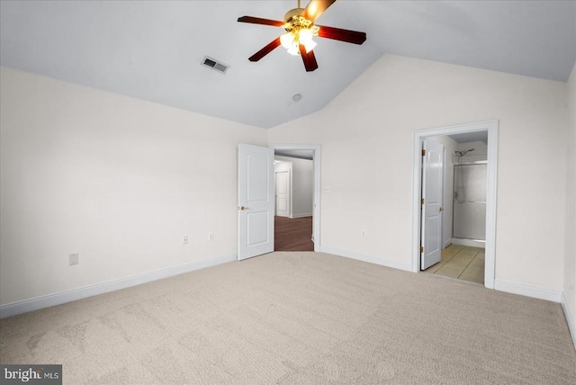 unfurnished bedroom with lofted ceiling, ceiling fan, carpet flooring, visible vents, and baseboards