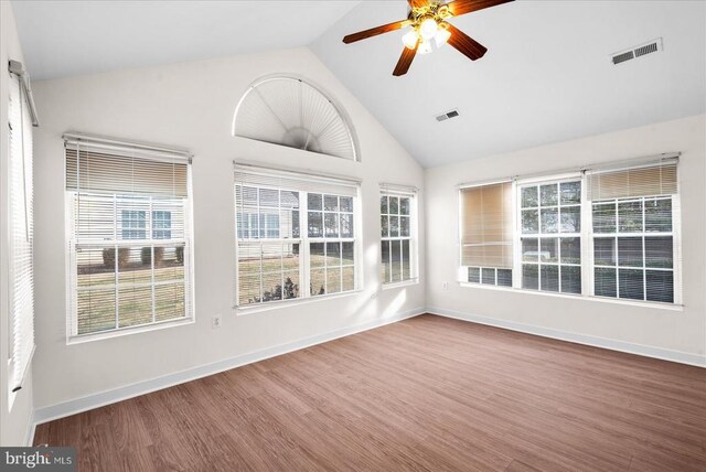 unfurnished sunroom with a healthy amount of sunlight, visible vents, and ceiling fan