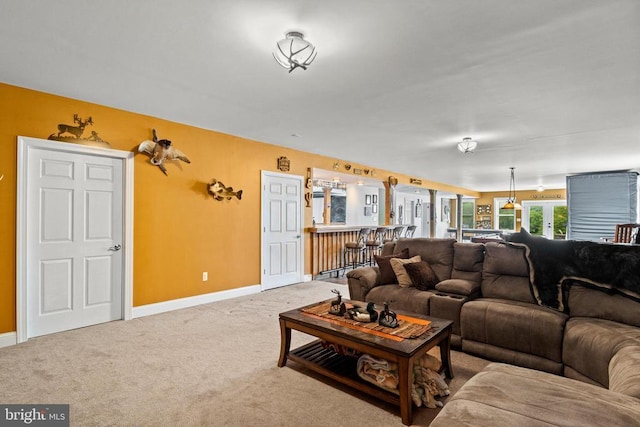 carpeted living room featuring indoor bar