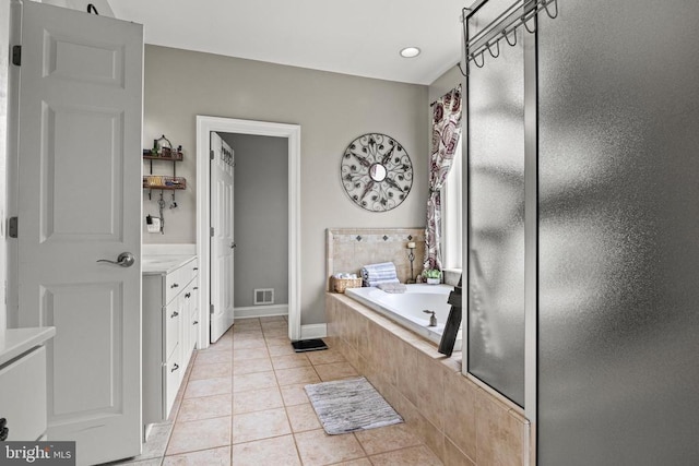 bathroom featuring vanity, plus walk in shower, and tile patterned flooring