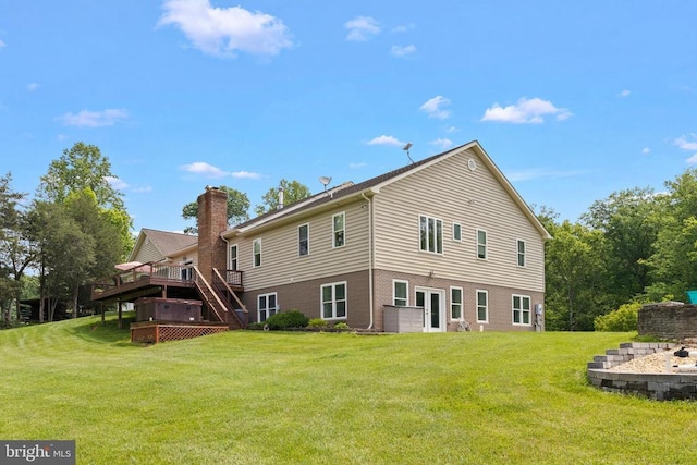 back of property with a wooden deck and a yard