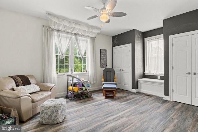 sitting room featuring ceiling fan and wood-type flooring