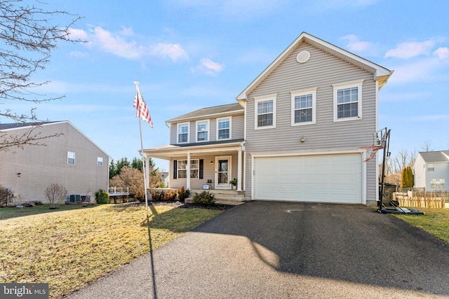 front facade featuring a porch, a garage, and a front lawn