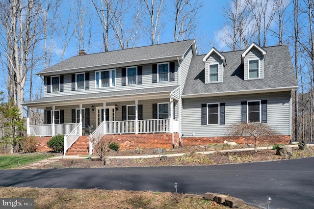 view of front of house with a porch and a shingled roof