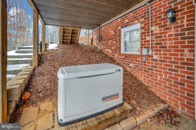 exterior details featuring a power unit and brick siding