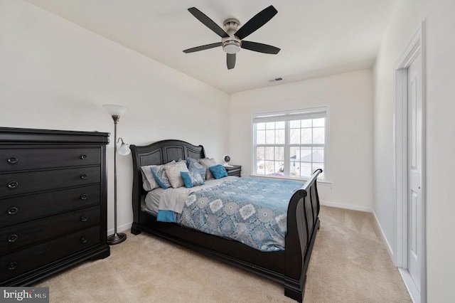 bedroom featuring baseboards, light carpet, and a ceiling fan