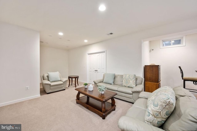 living area featuring recessed lighting, visible vents, baseboards, and light colored carpet