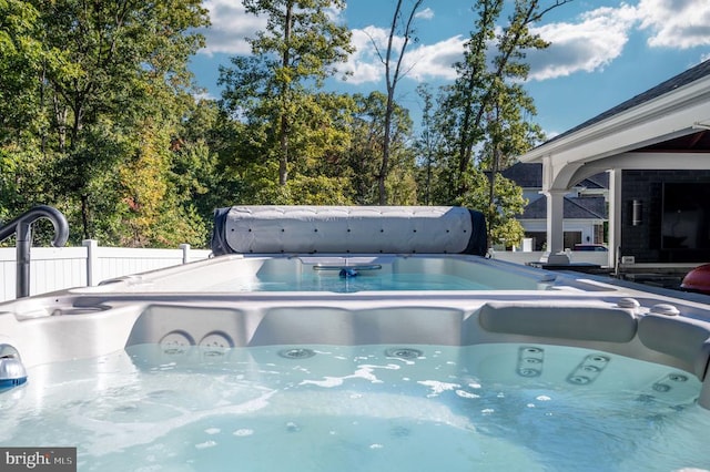 view of pool with a hot tub