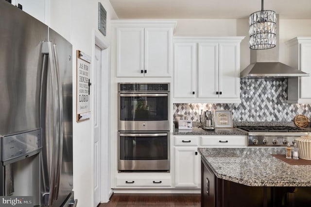 kitchen featuring dark stone counters, tasteful backsplash, appliances with stainless steel finishes, and white cabinets