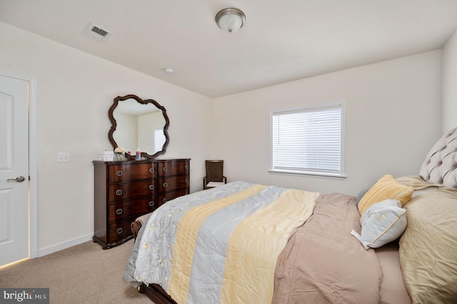 bedroom with baseboards, light carpet, and visible vents