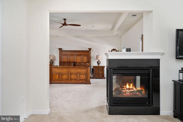 interior space with baseboards, a multi sided fireplace, and carpet flooring